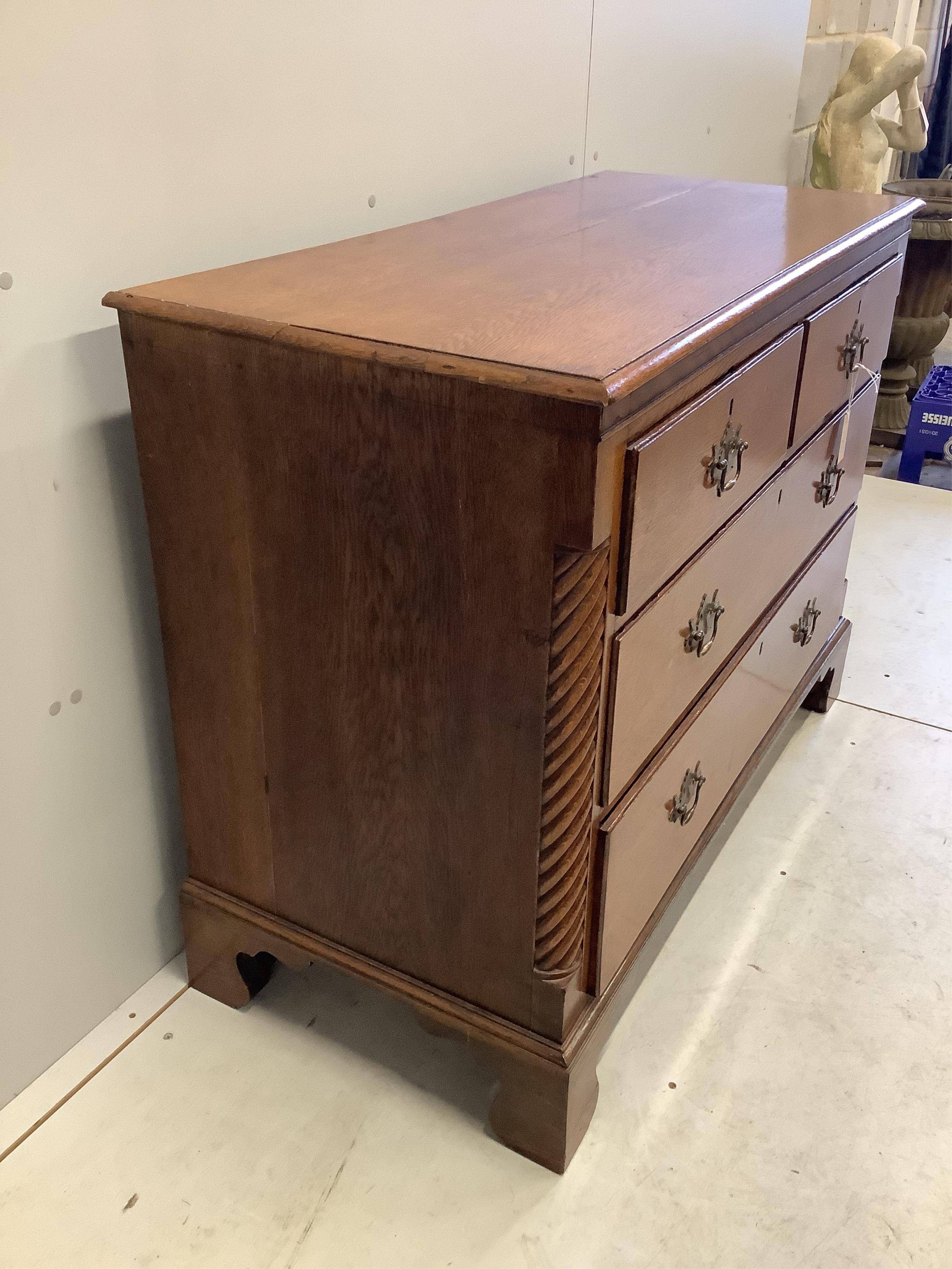 A George III oak four drawer chest, width 114cm, depth 51cm, height 88cm. Condition - fair